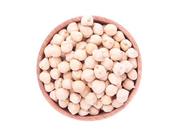 istock Chickpeas in a wooden bowl isolated on white background 513946666