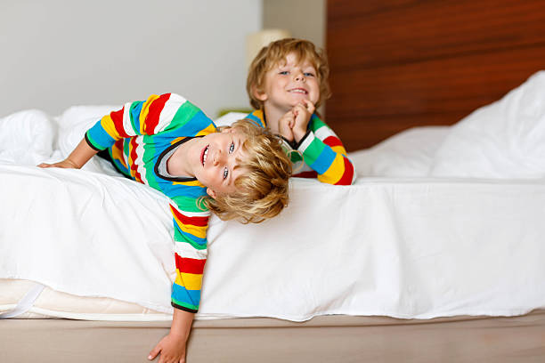 istock Two little sibling  boys having fun in bed after sleeping 513948702
