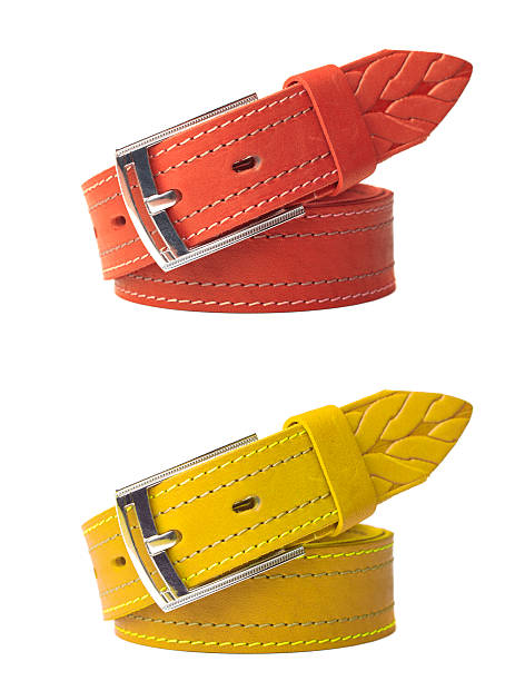 Brightly colored leather belts isolated Brightly colored leather belts isolated on white background yellow belt stock pictures, royalty-free photos & images