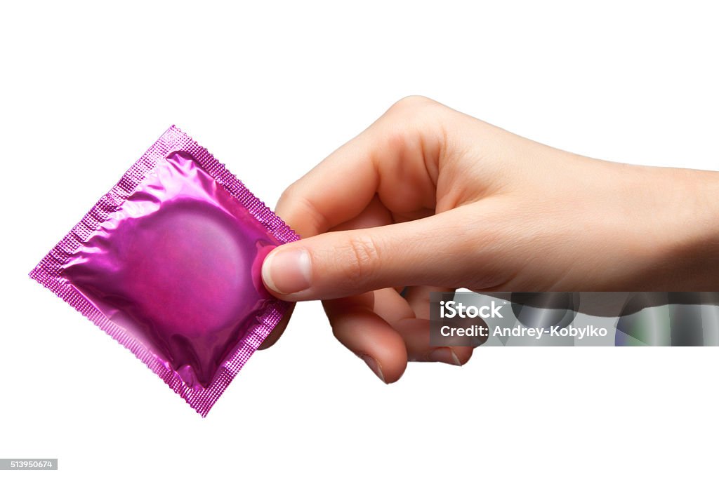 condom in hand Condom Stock Photo