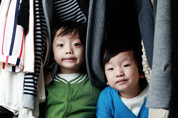 istock Brother playing in the closet 513951534