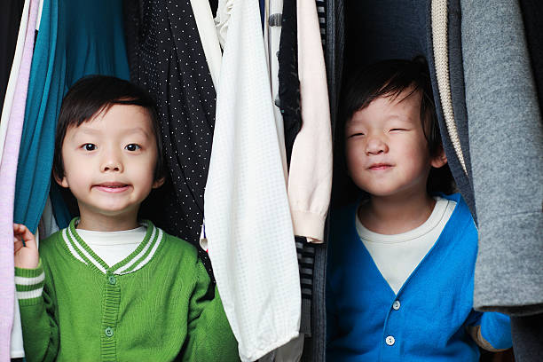 istock Brother playing in the closet 513951538