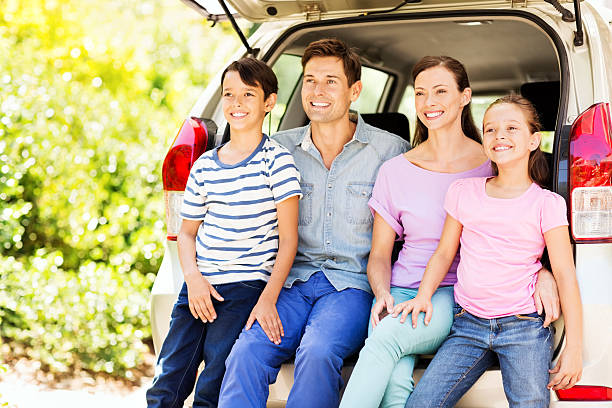 istock Family Looking Away While Sitting In Car Trunk 513954325