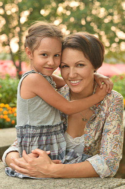 istock girl with mother in park 513954378