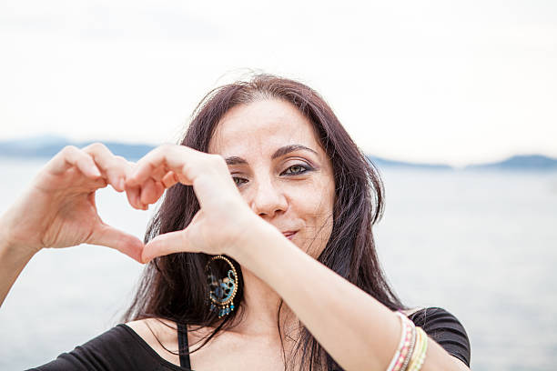 istock Woman Brunette making Heart Shape 513957917