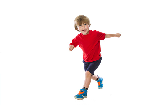 Four year old boy jumping and having fun in the Studio.