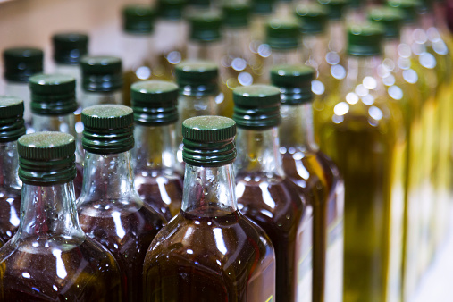 Bottles of olive oil  on counter of  market
