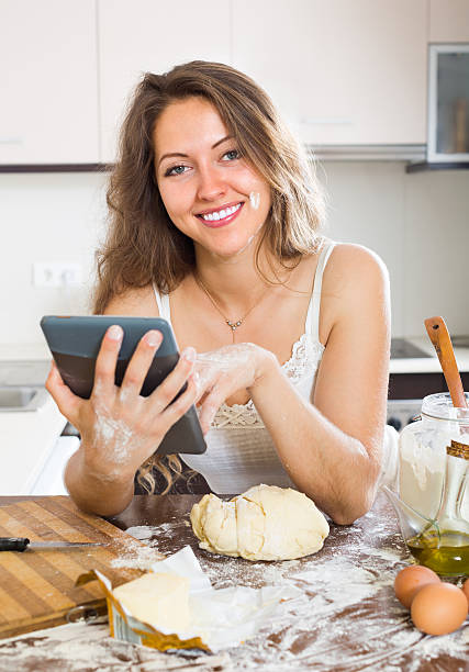 istock Housewife cooking with tablet at home 513959971