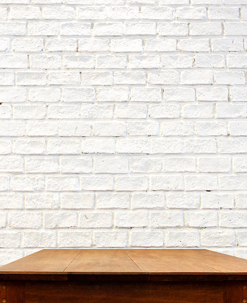 istock white brick wall and wooden table 513960983