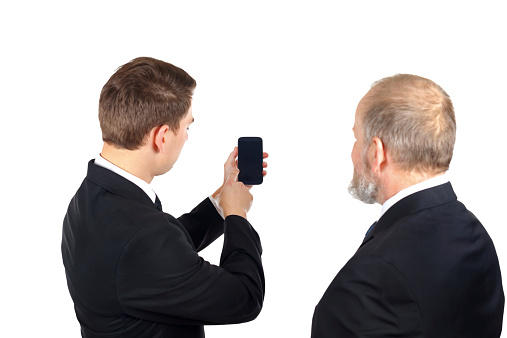 Portrait of two confident businessman checking the mobilephon