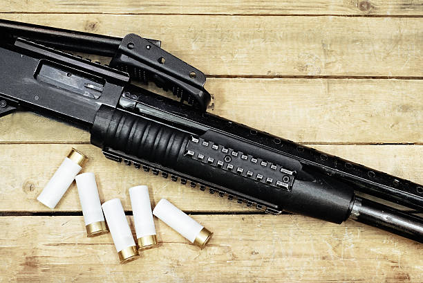istock gun and ammunitions on the wooden surface 513982866