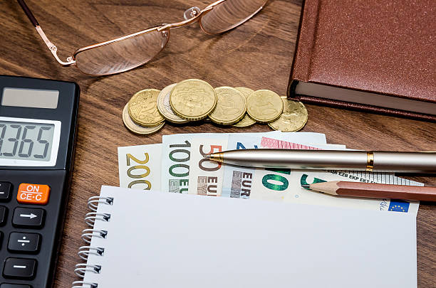 istock Blank paper with euro money, pen, calculator on table 513984266