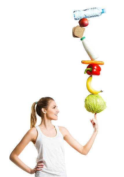 Beautiful young woman holding a balanced diet