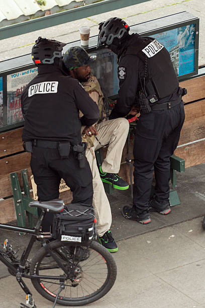 Law Enforcement Seattle, USA - March 2, 2016: Seattle Police arresting a man mid day in Pike Place Market for allegedly selling drugs after police witness an exchange. german social democratic party photos stock pictures, royalty-free photos & images