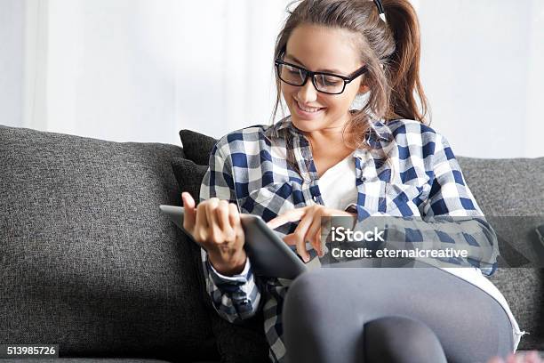 Using Tablet Stock Photo - Download Image Now - Young Women, One Woman Only, Sofa