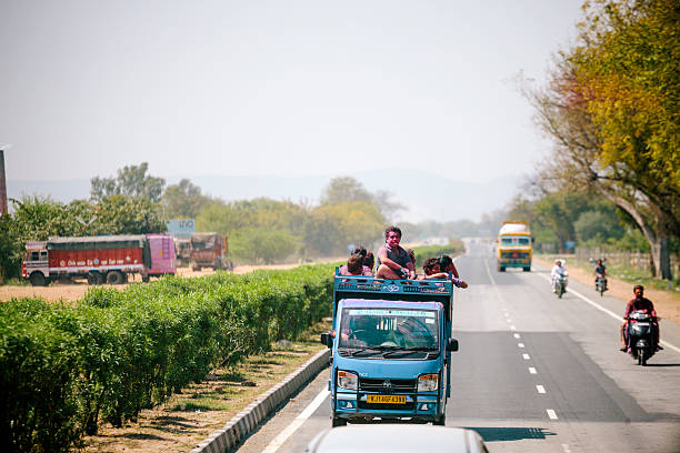 Rajasthan, India - March 17, 2014: A brightly painted truck travelling along a rural road, Rajasthan, India