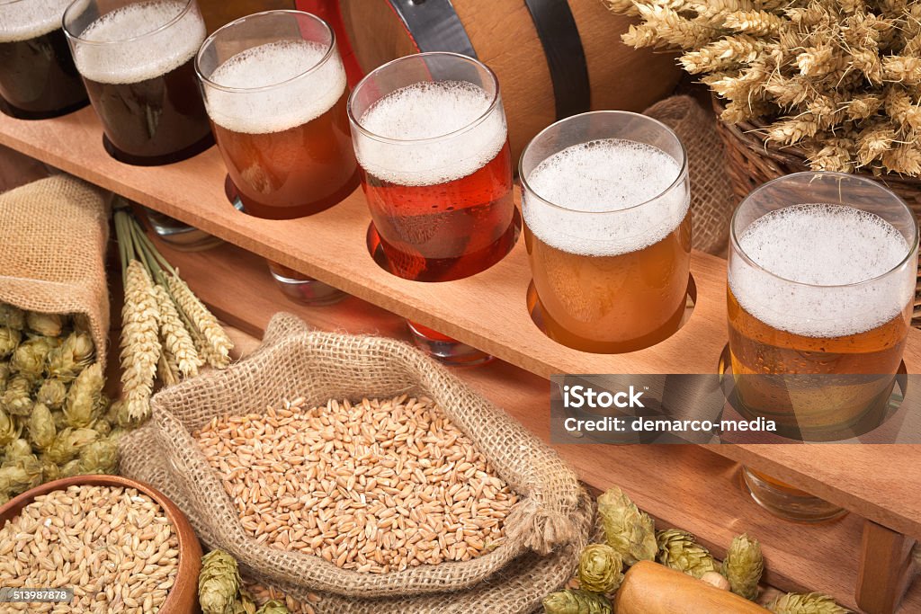 beer crate with beer glasses beer crate with many different beers, hops, wheat, grain, barley and malt Alcohol - Drink Stock Photo