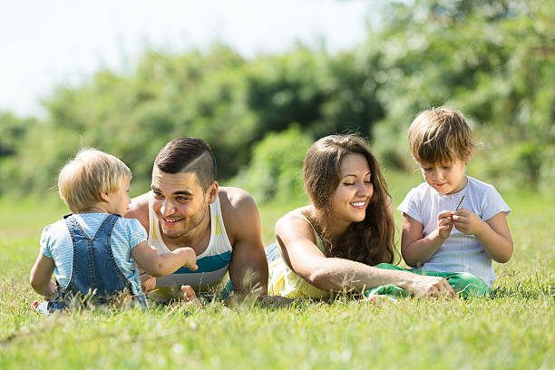 istock Parents with children laying in the grass 513987941