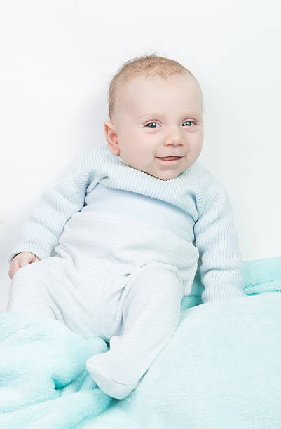 istock Happy child with blue eyes and turquoise romper 513988566