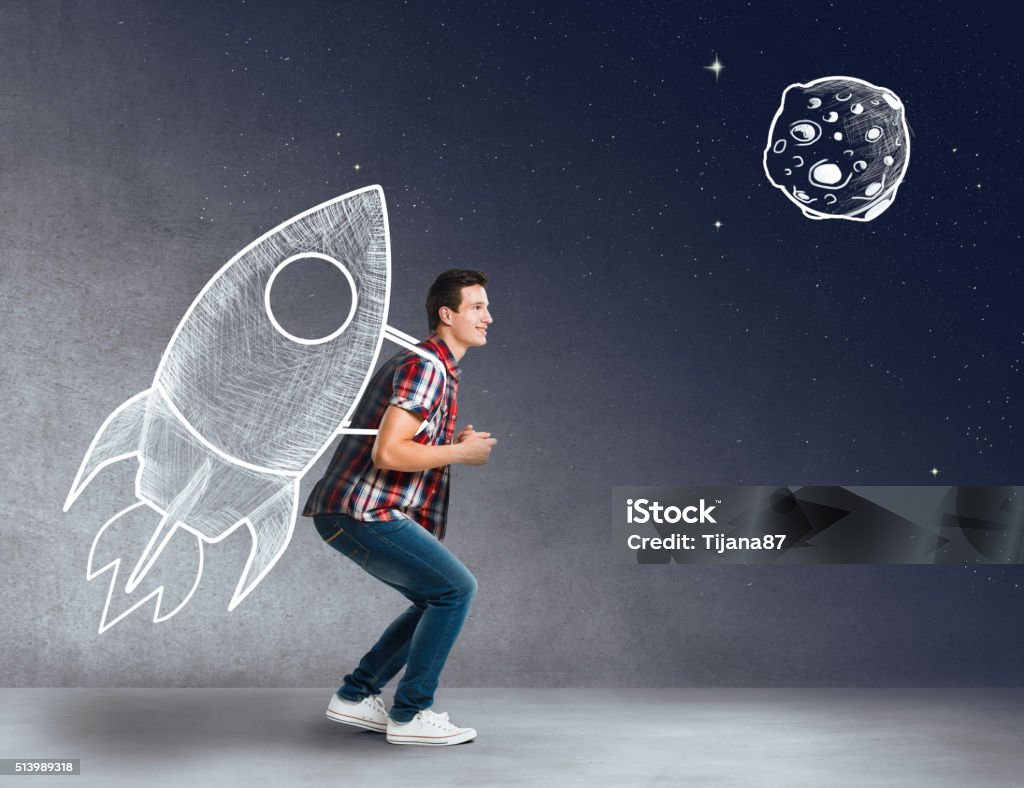 Young man with a rocket on his back Rocketship Stock Photo