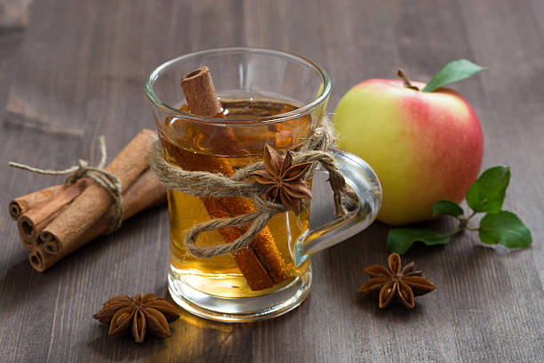 spiced apple cider and spices on a wooden table