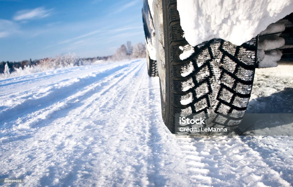 Closeup of car tires in winter morning Car tires an tracks on the sno Tire - Vehicle Part Stock Photo