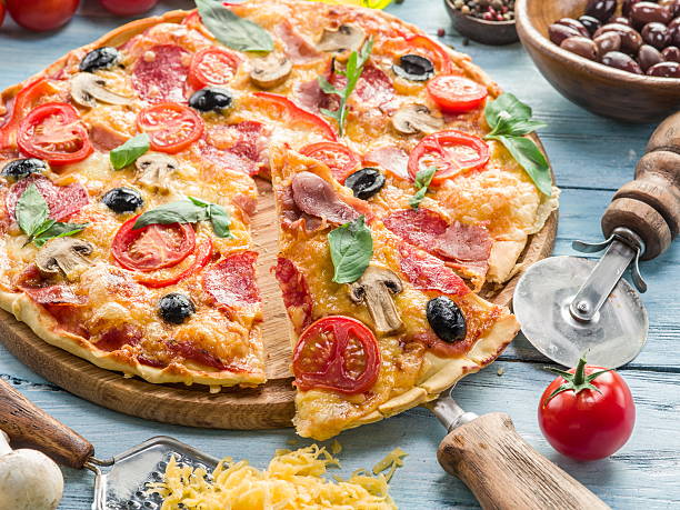 istock Pizza with mushrooms, salami and tomatoes. 513989850