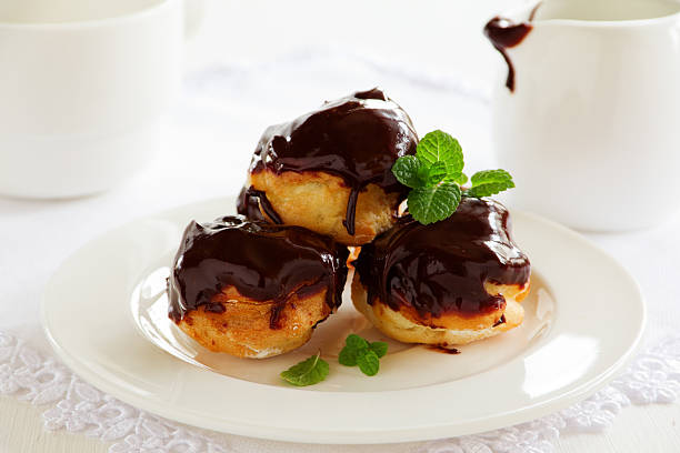istock profiteroles with cream and chocolate sauce. 513989901