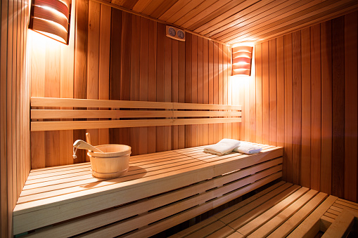 Sauna interior. Sauna is ready to receive guests. Photo made with available light, and with very nice warm tones.  