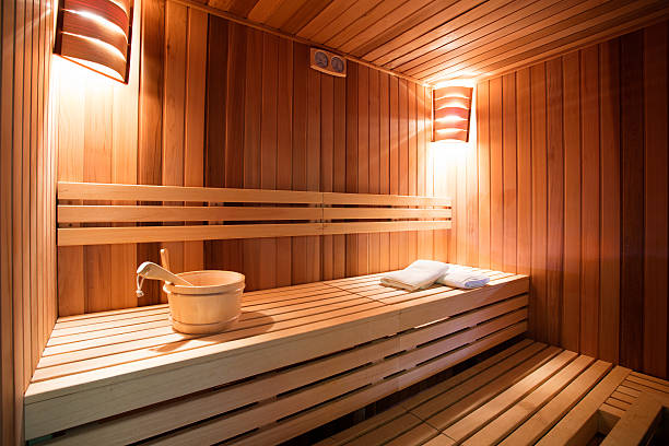 Indoor sauna Sauna interior. Sauna is ready to receive guests. Photo made with available light, and with very nice warm tones.   sauna stock pictures, royalty-free photos & images