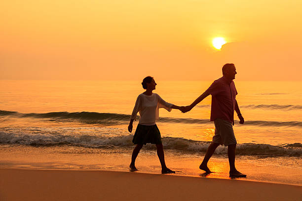 istock Senior couple at golden beach 513990312