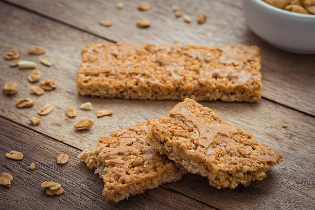 istock Granola bars on wooden table and peanuts 513991072