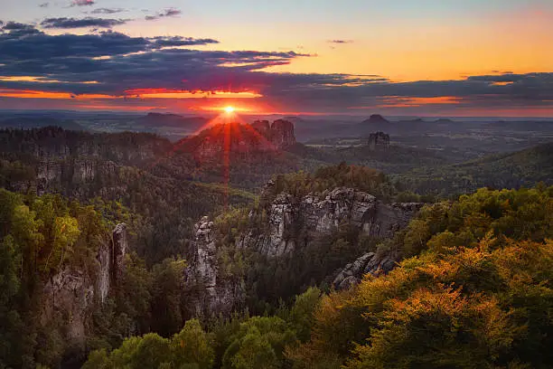 colorful sunset view on Schrammsteine from Carolafelsen in the national park Saxon Switzerland, Germany