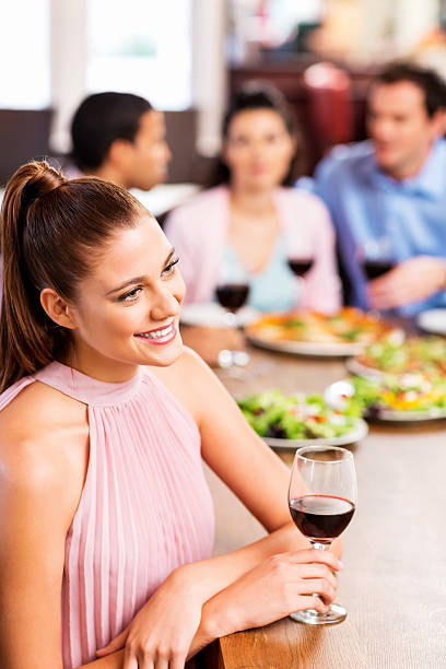 istock Beautiful Woman Having Dinner With Friends At Restaurant 513992335