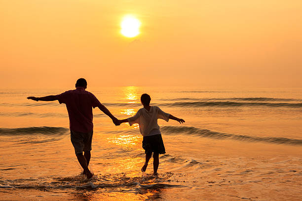 istock Senior couple at golden beach 513996888