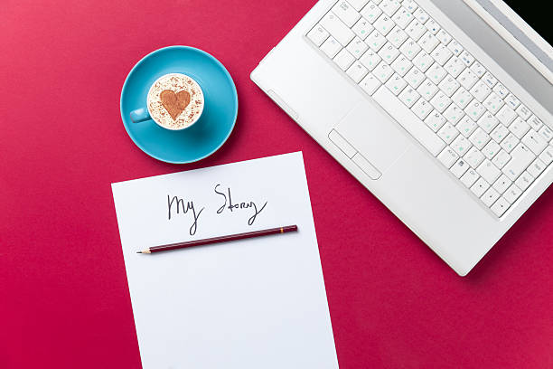 istock paper, coffee and laptop lying on the table 513996954