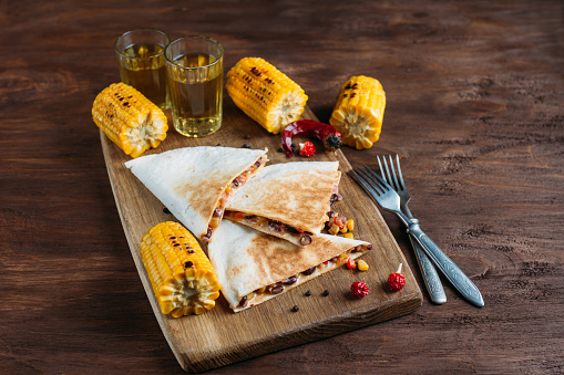 Mexican vegetarian quesadilla with cheese on a dark background