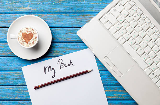 istock paper, coffee and laptop lying on the table 513998518