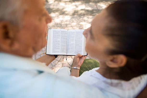 istock Hispanic elderly couple reading a Bible 513998824
