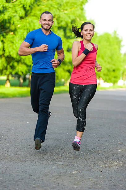 istock Runners training outdoors working out. City running couple jogging outside 514003062