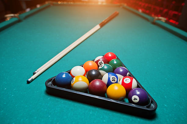 istock Billiard balls in a pool table at triangle with billiard cue 514004048