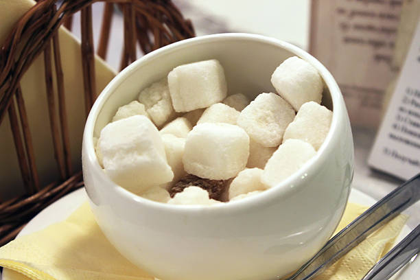 Sugar. Sugar cubes. Sugar-bowl. Sugar-basin. Shallow depth of field.