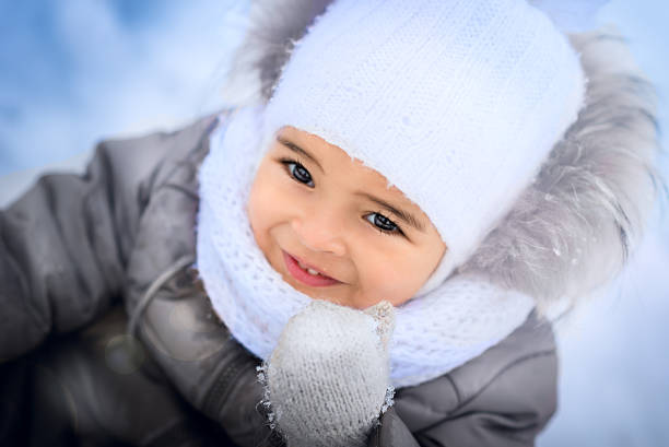 Happy Mixed Race Toddler Girl in winter.