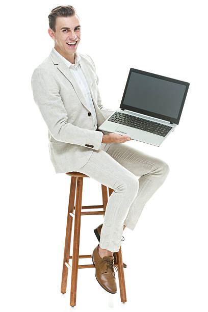 istock Cheerful smart casual man on stool & showing laptop 514027701