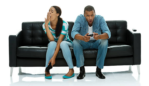 istock Man playing video game while female yawing 514027759