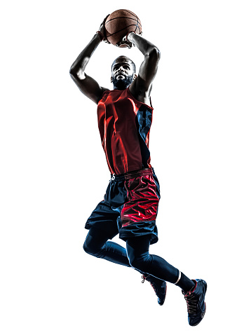 one african man basketball player jumping throwing in silhouette isolated white background
