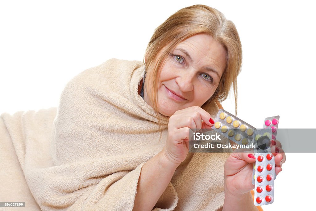 Let's be well Beautiful aged woman taking pills to be well 50-59 Years Stock Photo
