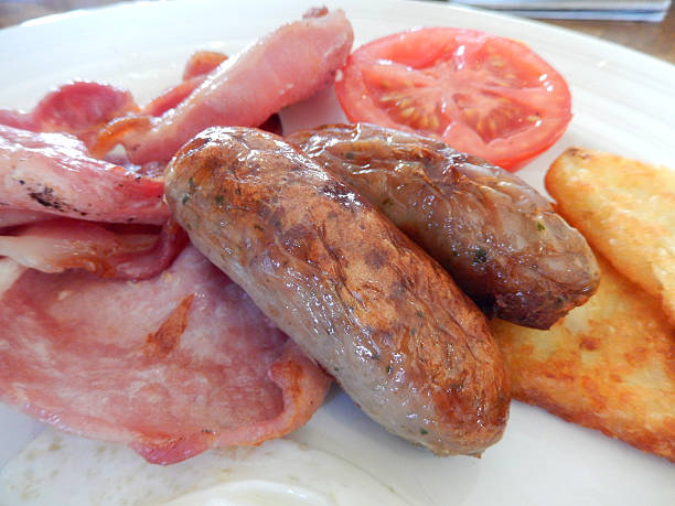 istock Image of fried breakfast with sausages, bacon, hash brown, tomato 514028997
