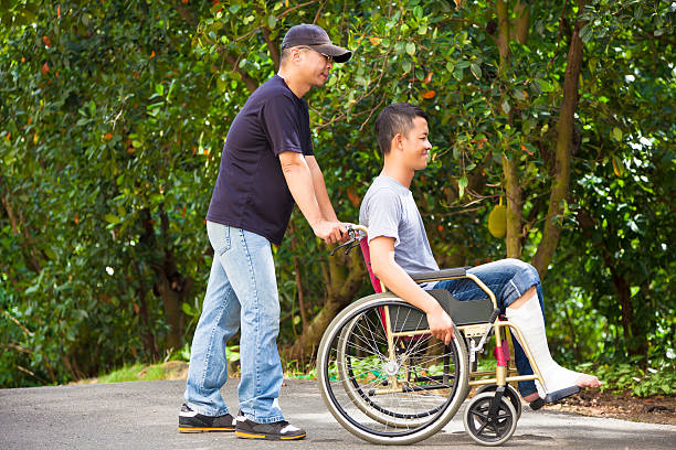 istock young man sitting on a wheelchair with his brother 514030119