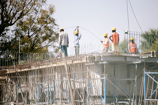 Rajasthan, India - March 13, 2014: Workmen build a concrete house. Udaipur, Rajasthan, India